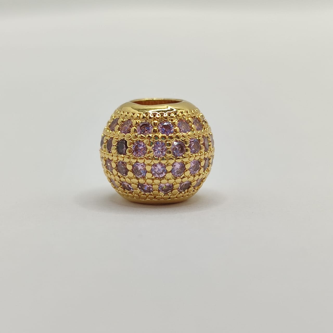 CIRCON BOLSA DE FUEGO DORADO CON CRISTAL ROSADO