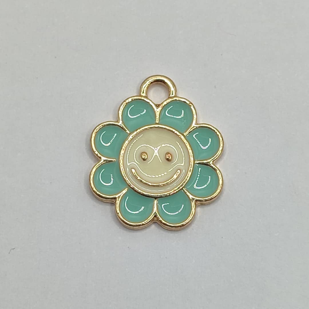 DIJE ESMALTADO FLOR CON SONRISA TURQUESA