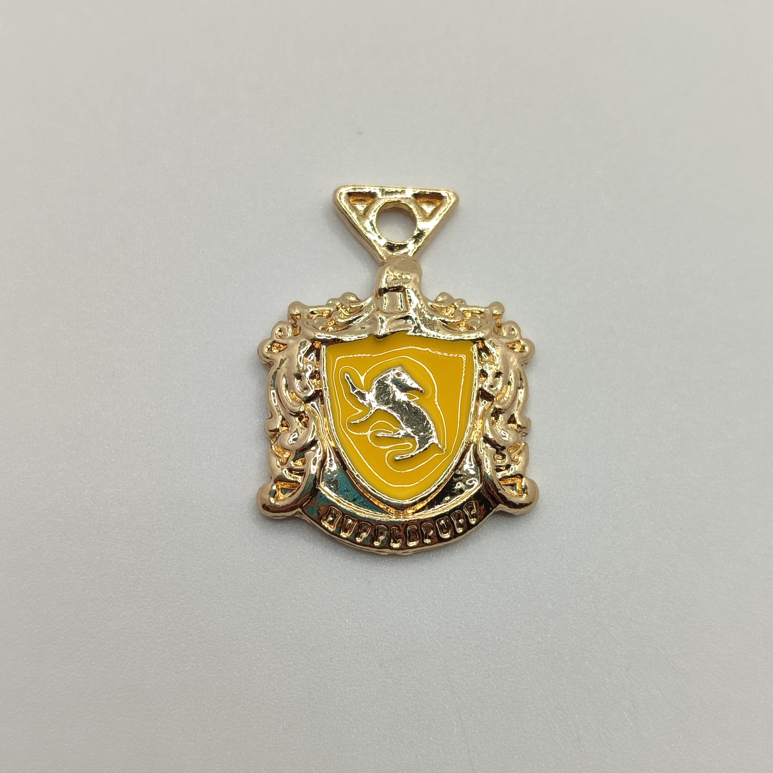 DIJE ESMALTADO MEDALLA HARRY PO TTER LEON