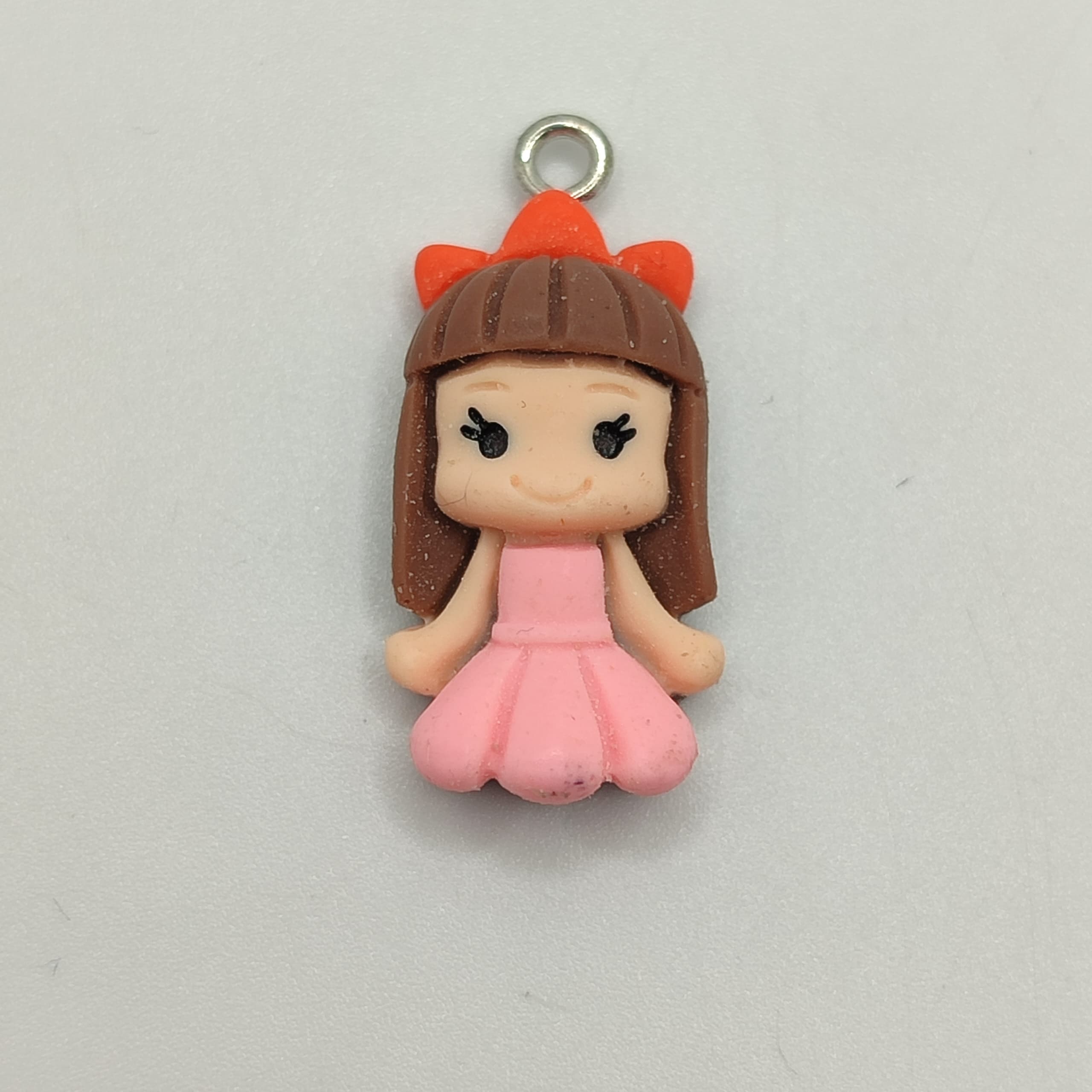 RESINA DE NIÑA CON VESTIDO ROSADO Y LAZO